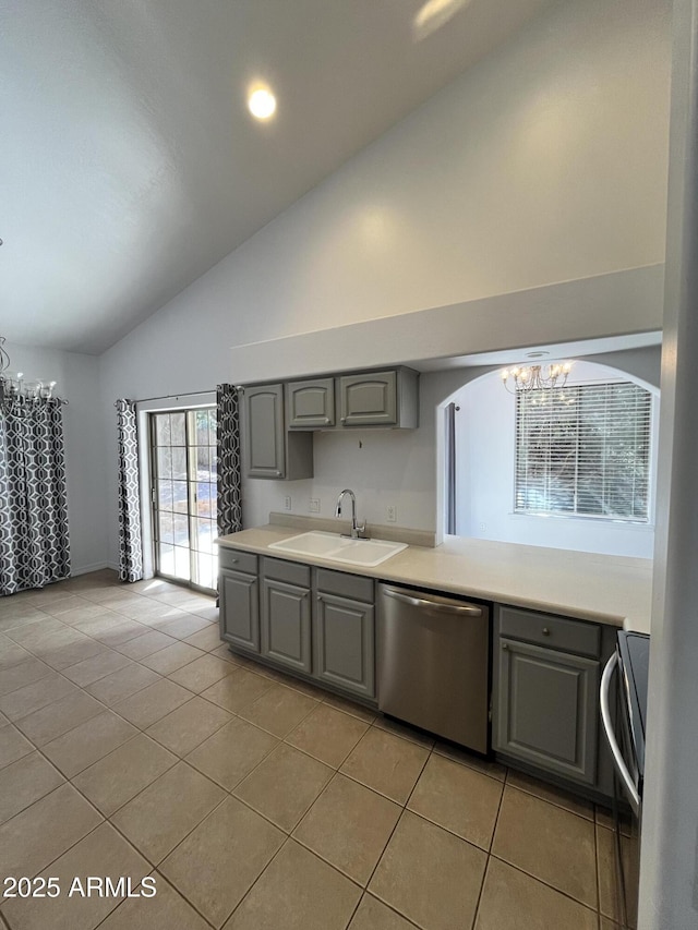 kitchen with gray cabinetry, sink, stainless steel dishwasher, a chandelier, and light tile patterned floors