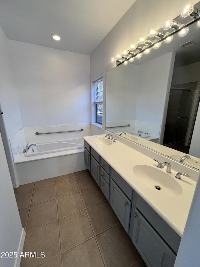 bathroom with tile patterned floors, vanity, and independent shower and bath