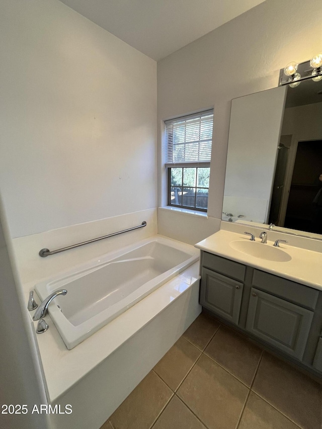 bathroom featuring vanity, tile patterned floors, and a bathing tub