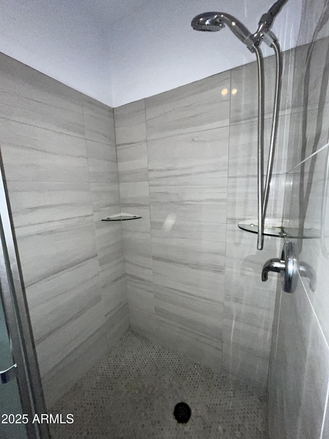 bathroom with a tile shower