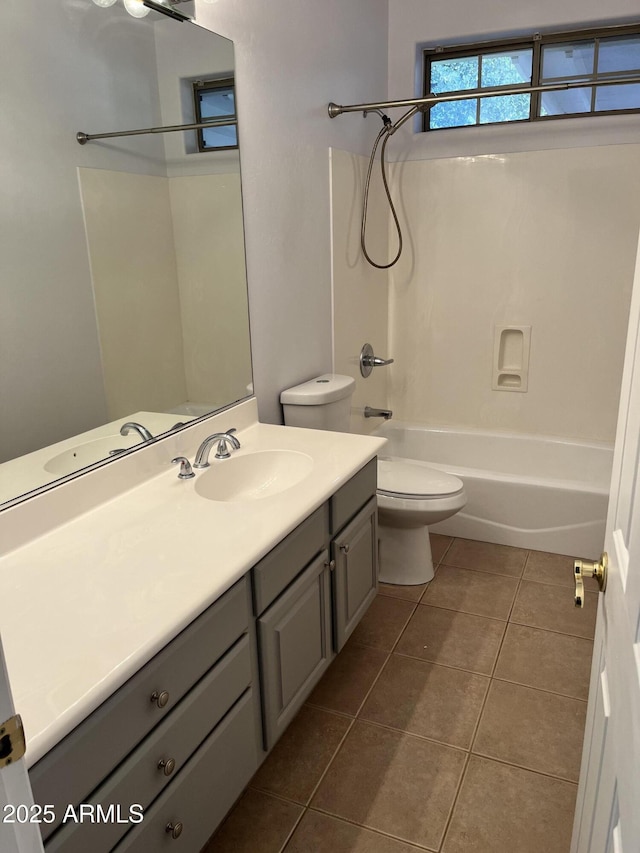 full bathroom featuring tile patterned floors, vanity, bathing tub / shower combination, and toilet