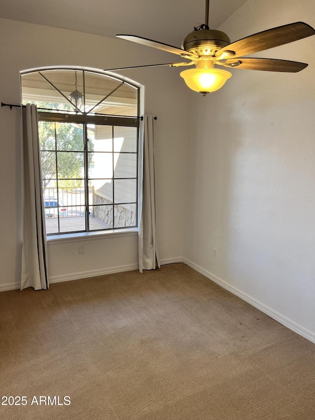 unfurnished room with carpet, vaulted ceiling, and ceiling fan