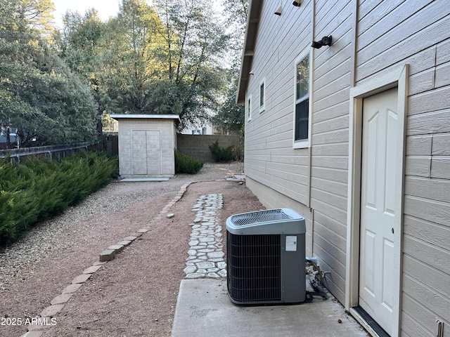 view of yard featuring central AC and a storage shed