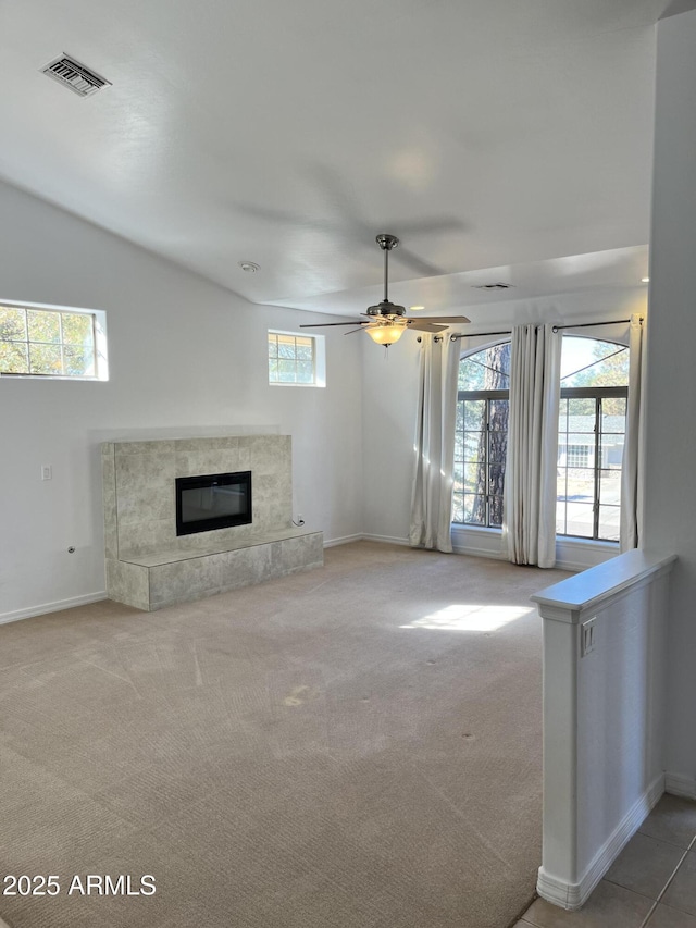 unfurnished living room with carpet, a premium fireplace, and ceiling fan