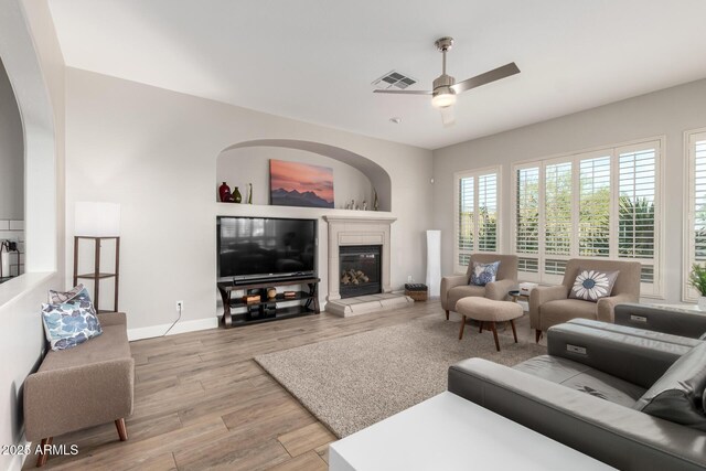 16201 S 29th Ave, Phoenix, AZ 85045 - living area featuring visible vents, a glass covered fireplace, light wood-style floors, baseboards, and ceiling fan