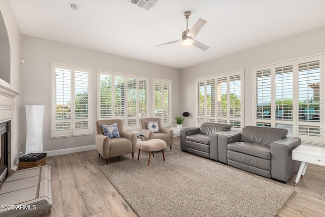 16201 S 29th Ave, Phoenix, AZ 85045 - living area with visible vents, a fireplace with flush hearth, light wood finished floors, and ceiling fan