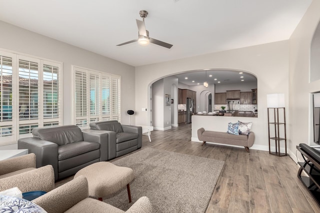 16201 S 29th Ave, Phoenix, AZ 85045 - living room featuring baseboards, ceiling fan, recessed lighting, arched walkways, and light wood finished floors