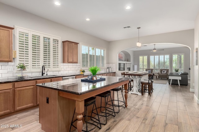 16201 S 29th Ave, Phoenix, AZ 85045 - kitchen with a breakfast bar area, visible vents, arched walkways, tasteful backsplash, and a sink