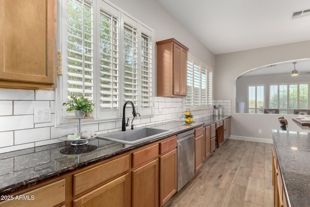 16201 S 29th Ave, Phoenix, AZ 85045 - kitchen featuring visible vents, decorative backsplash, light wood-style floors, a sink, and dishwasher