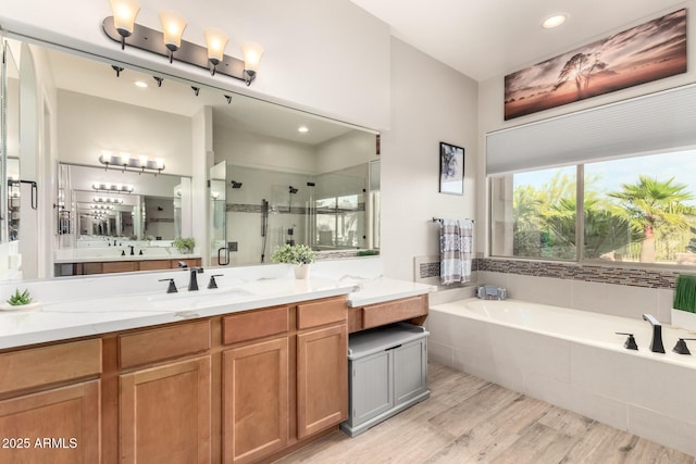 16201 S 29th Ave, Phoenix, AZ 85045 - bathroom featuring a bath, a shower stall, wood finished floors, vanity, and recessed lighting