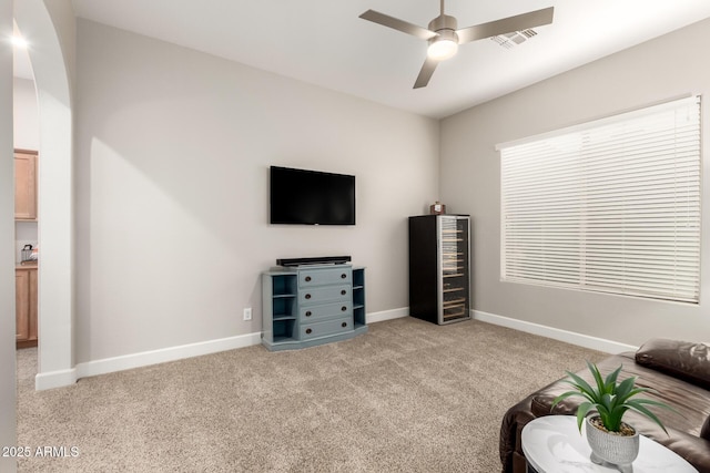 16201 S 29th Ave, Phoenix, AZ 85045 - living area featuring visible vents, wine cooler, baseboards, light colored carpet, and a ceiling fan