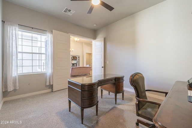 carpeted home office featuring ceiling fan