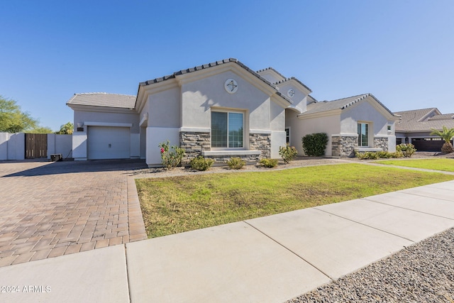 view of front of house featuring a garage and a front yard