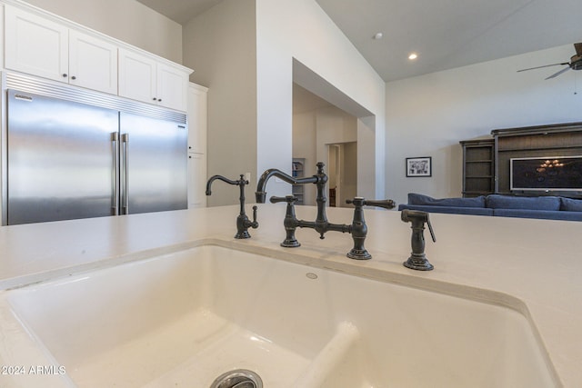 interior details featuring ceiling fan, stainless steel built in fridge, and sink