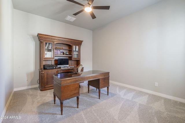 carpeted office space featuring ceiling fan