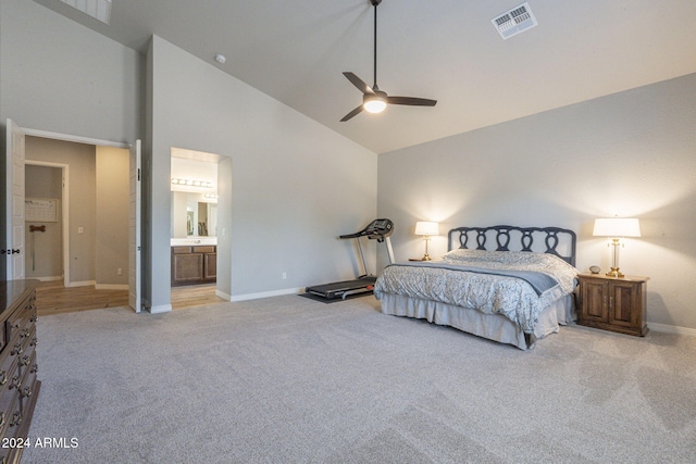 bedroom featuring high vaulted ceiling, light colored carpet, ceiling fan, and ensuite bath