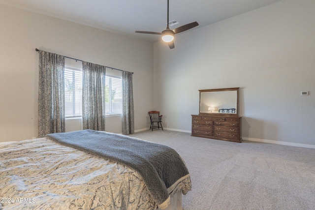 carpeted bedroom with ceiling fan and lofted ceiling