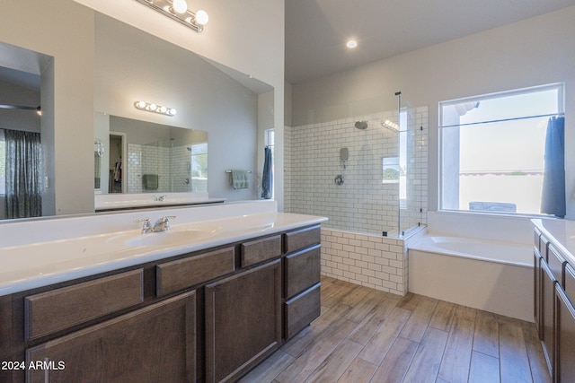 bathroom featuring hardwood / wood-style floors, vanity, and separate shower and tub