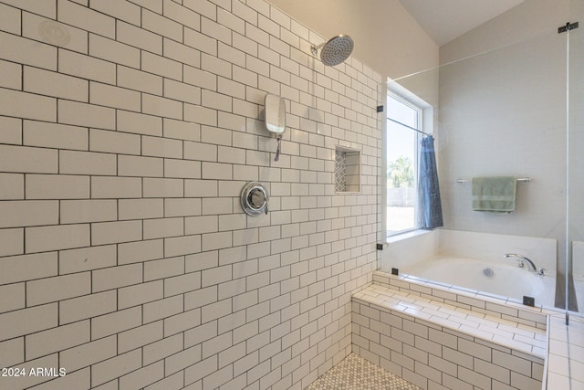 bathroom featuring lofted ceiling and independent shower and bath