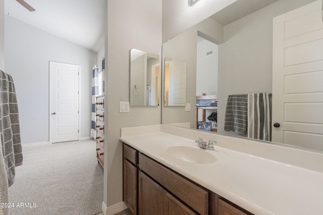 bathroom featuring vanity and lofted ceiling