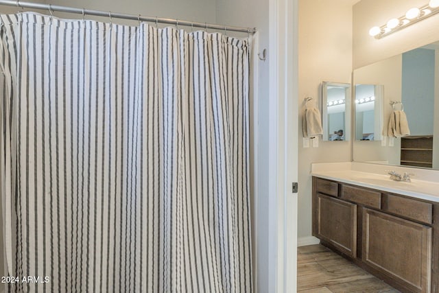 bathroom featuring vanity, wood-type flooring, and a shower with shower curtain