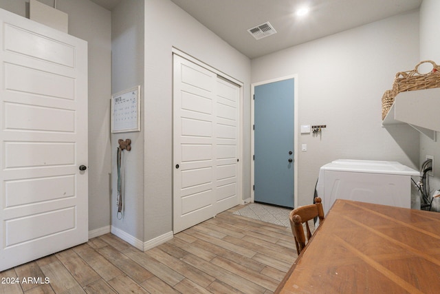 laundry room with light hardwood / wood-style flooring