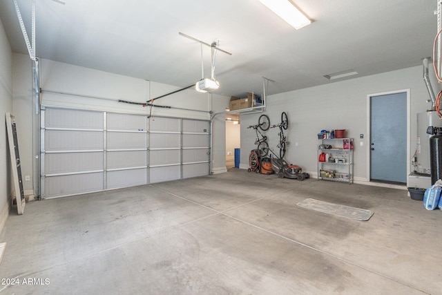 garage with water heater and a garage door opener