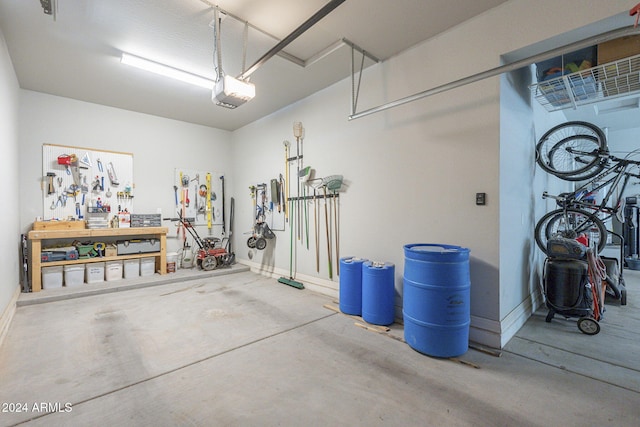 garage with a workshop area and a garage door opener