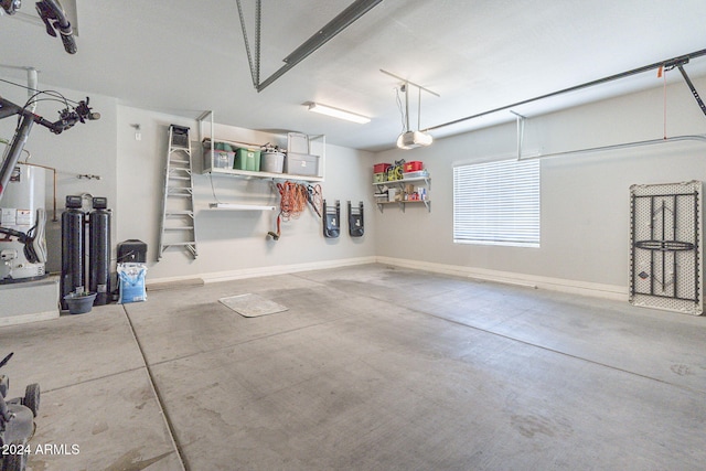 garage featuring water heater and a garage door opener