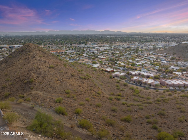 aerial view at dusk featuring a mountain view