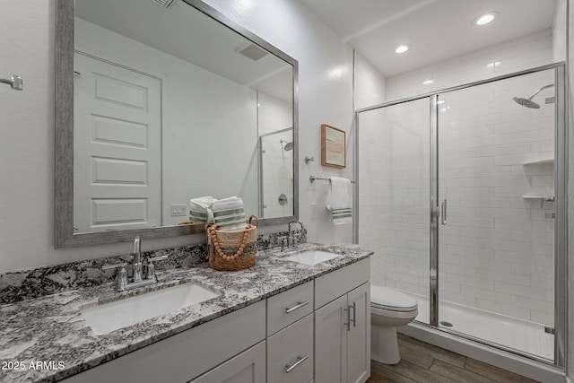 bathroom featuring vanity, toilet, and walk in shower