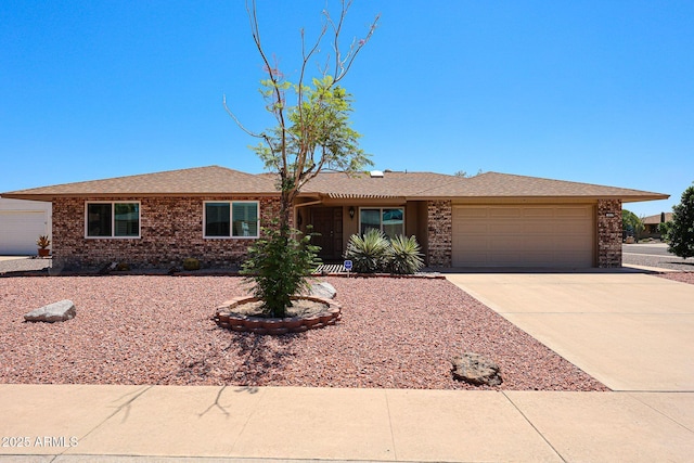 single story home with a garage, brick siding, driveway, and a shingled roof