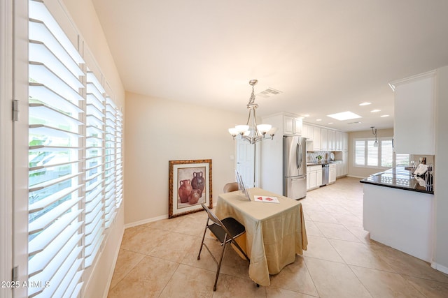 dining area with light tile patterned floors, a chandelier, recessed lighting, and baseboards