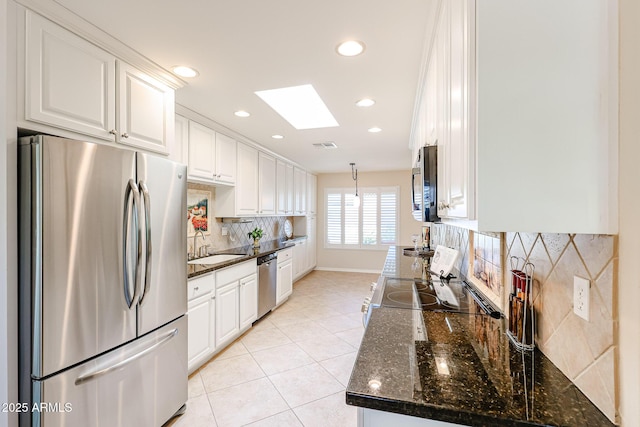 kitchen with stainless steel appliances, white cabinets, recessed lighting, tasteful backsplash, and light tile patterned floors
