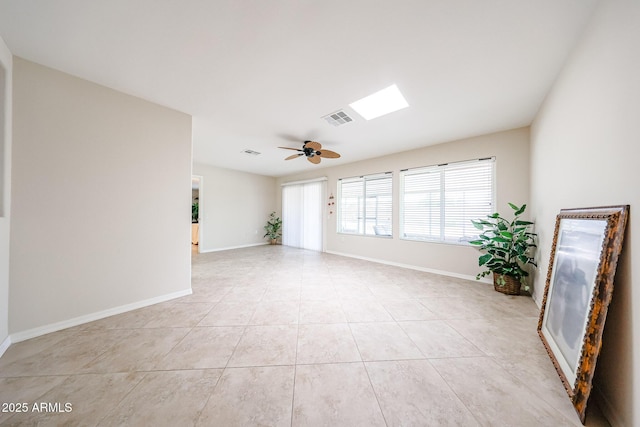 spare room with ceiling fan, baseboards, and light tile patterned floors