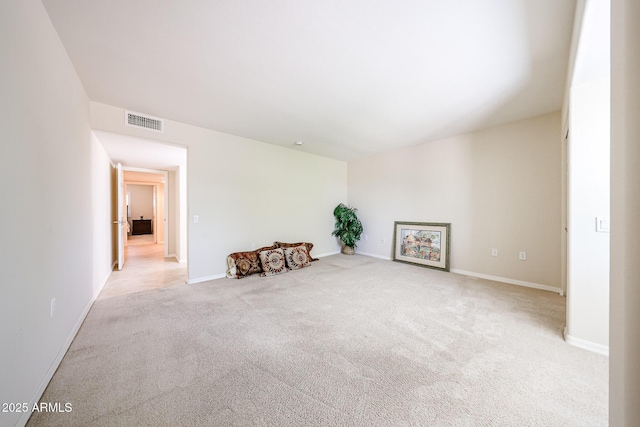 carpeted empty room with baseboards
