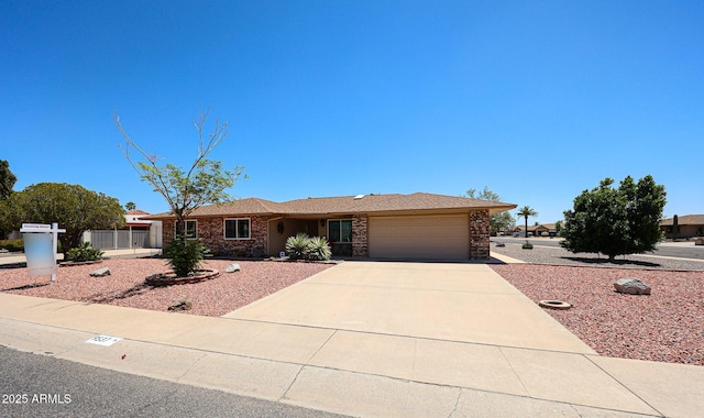 single story home featuring a garage, concrete driveway, and brick siding