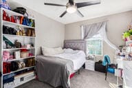 carpeted bedroom with ceiling fan