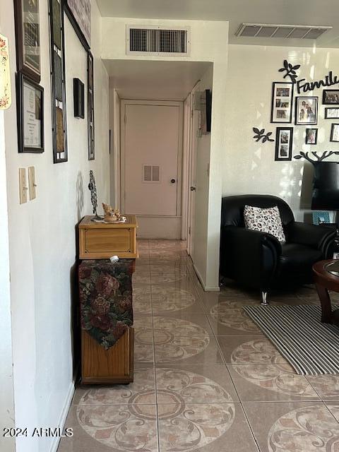 hallway featuring tile patterned flooring