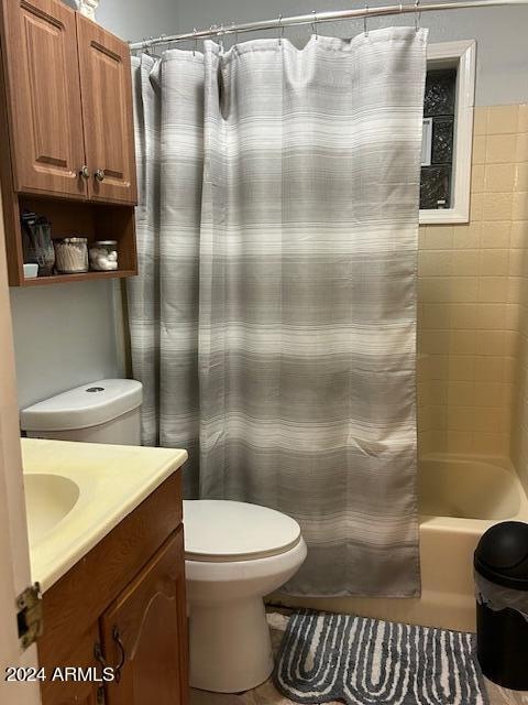 full bathroom featuring vanity, toilet, and shower / tub combo