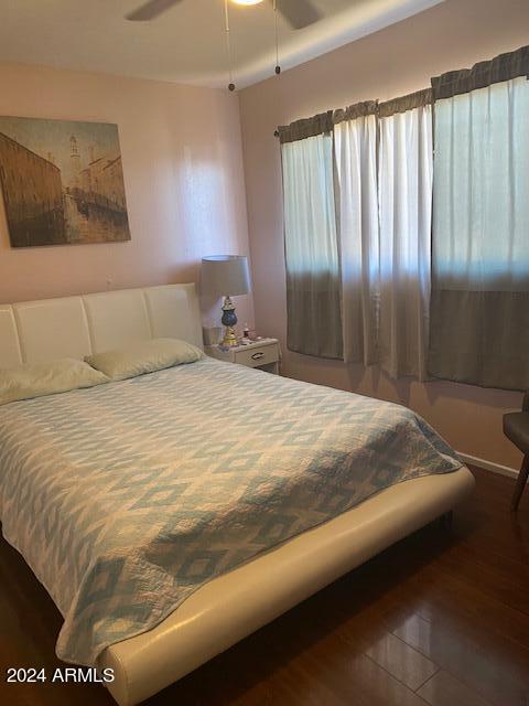 bedroom with ceiling fan and dark hardwood / wood-style floors