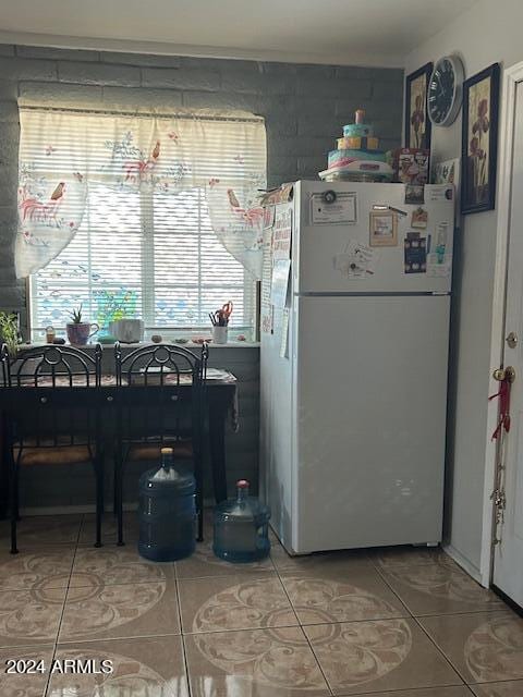 kitchen featuring tile patterned floors and white fridge