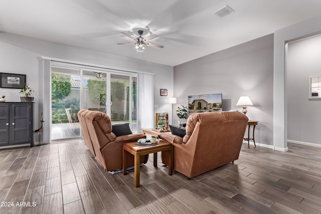 living room featuring dark hardwood / wood-style flooring and ceiling fan