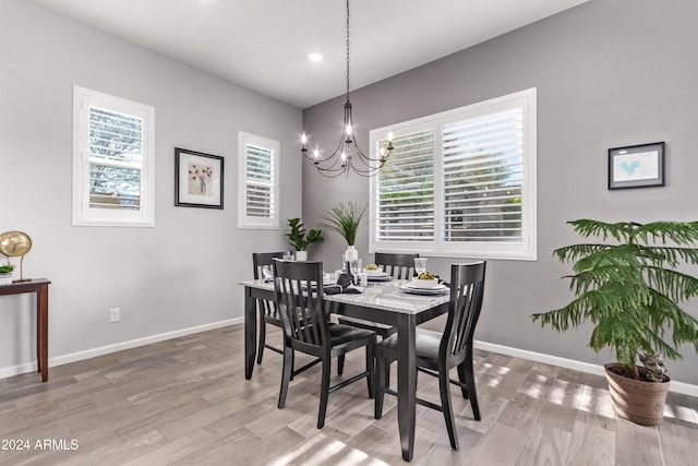 dining room with wood-type flooring and a chandelier