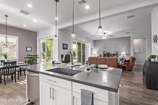 kitchen with sink, decorative light fixtures, an island with sink, wood-type flooring, and white cabinets