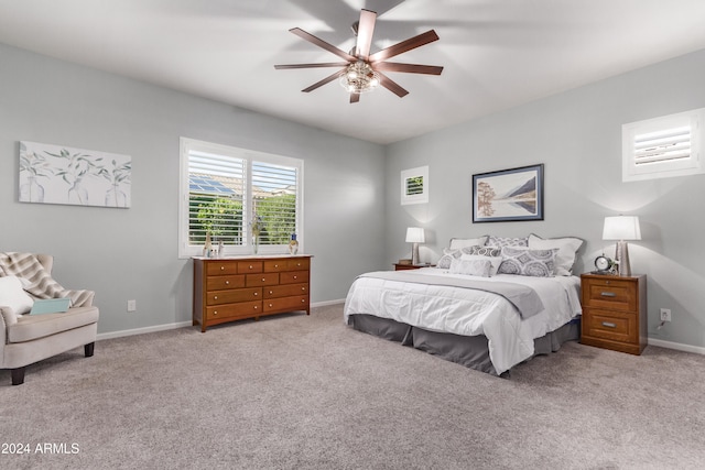 bedroom with ceiling fan and light carpet