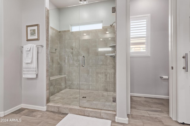 bathroom with walk in shower and wood-type flooring