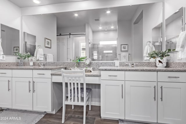 bathroom featuring walk in shower, vanity, and hardwood / wood-style floors