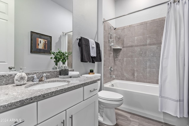 full bathroom with toilet, shower / bath combo, vanity, and wood-type flooring