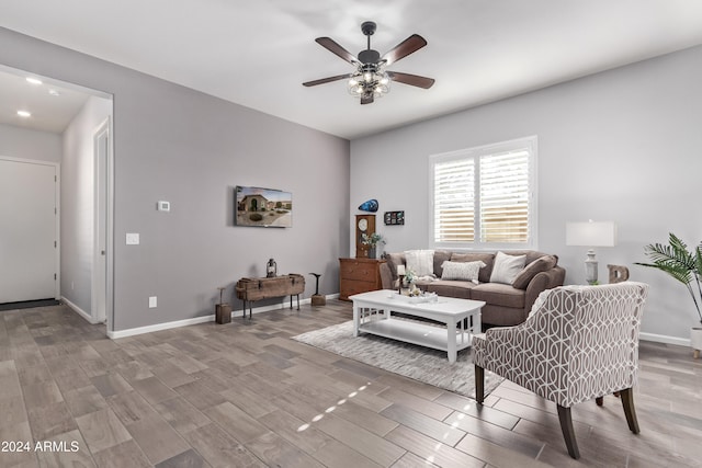 living room with light hardwood / wood-style floors and ceiling fan